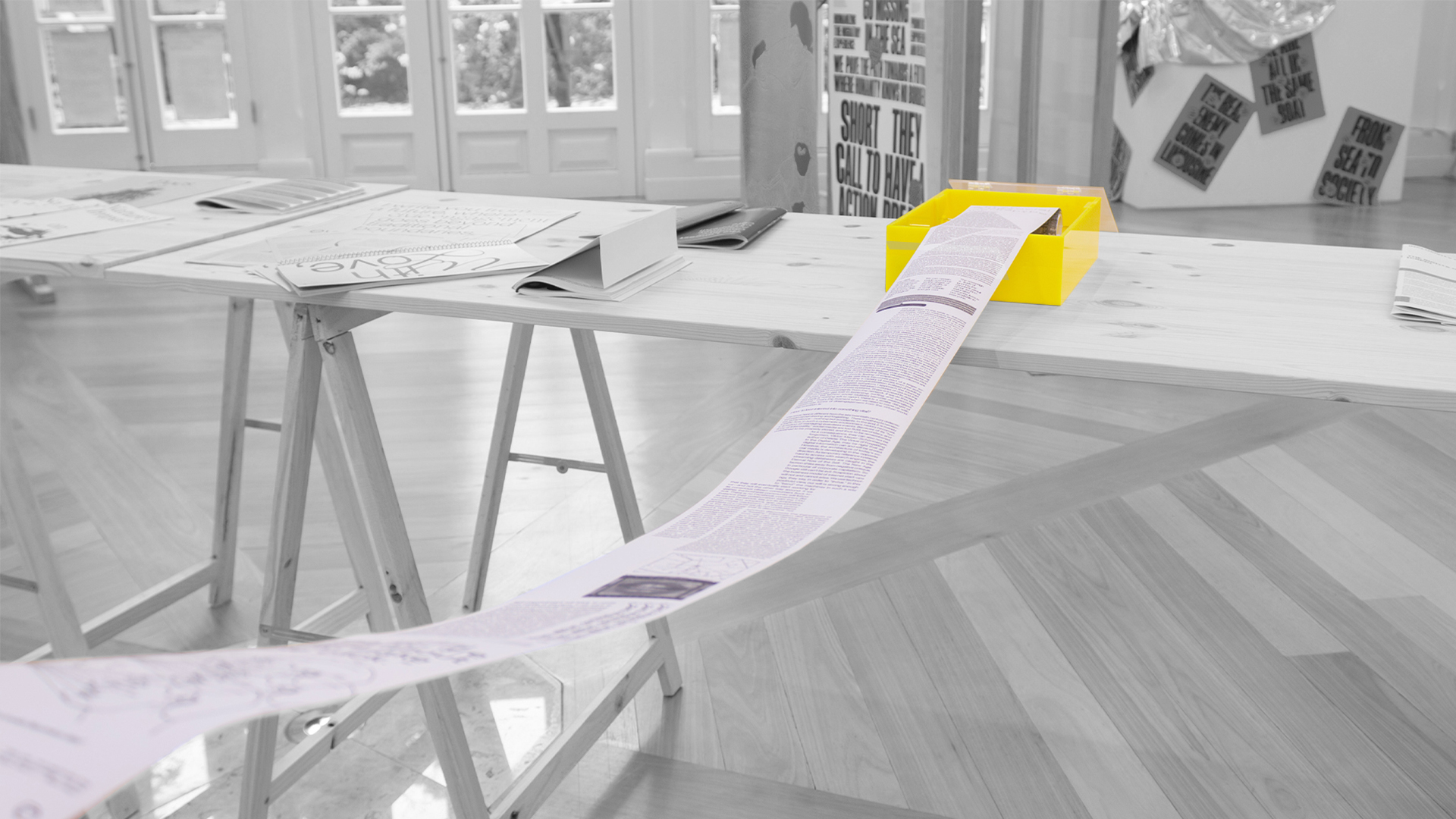 paradox of distractions exbibition material detailed on wood table